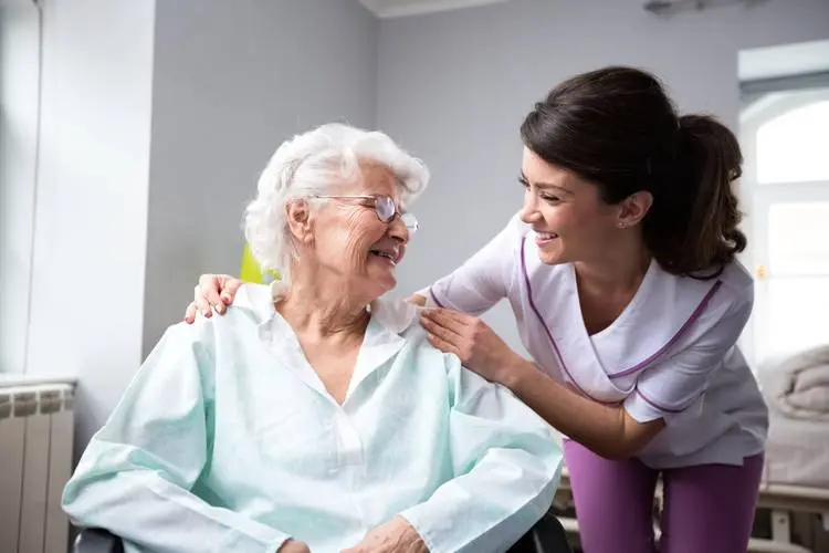 Caregiver holding hands with an older adult