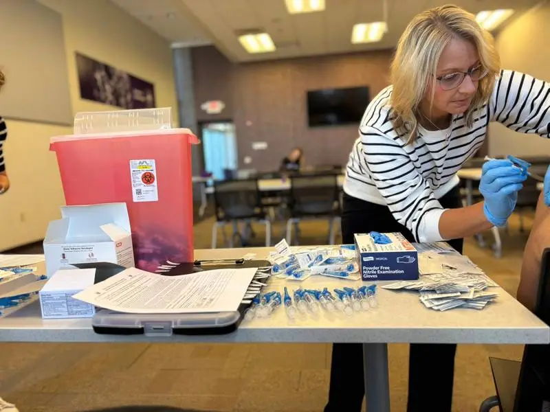 Pharmacy staff member preparing an immunization for a patient